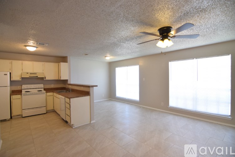 A kitchen with a fan on the ceiling and a countertop.