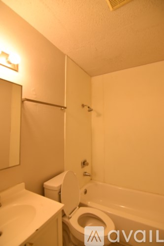 A bathroom with a toilet, sink, and bathtub.