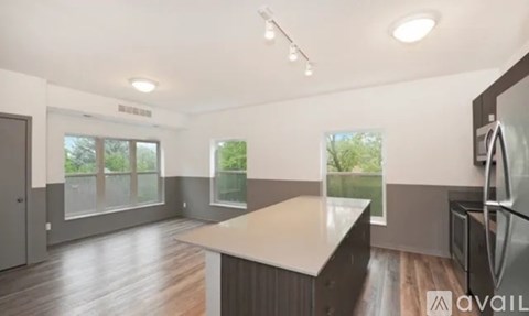 A kitchen with a refrigerator on the right side.