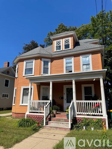 A two-story house with a porch and a balcony.