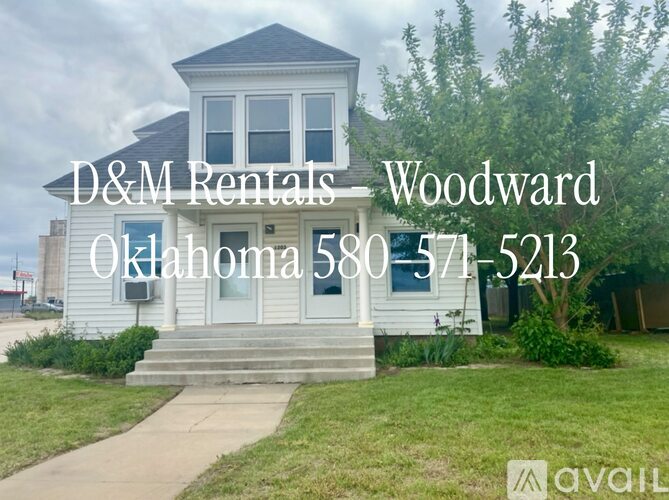 A house with the text D&M Rentals Woodward Oklahoma 580 371-5213 in front of it.