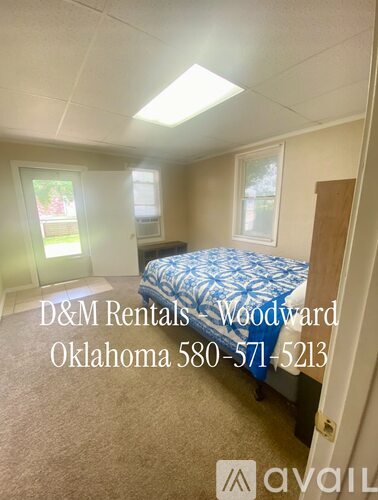 A bedroom with a bed, a window, and a door is available for rent.