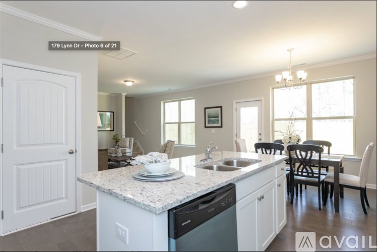 A kitchen with a white countertop and black appliances.