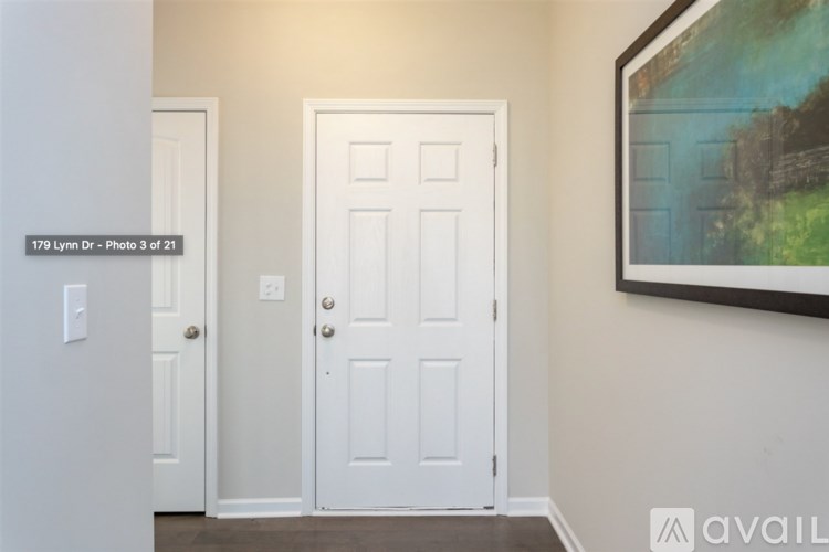 A white door is in the middle of a hallway.
