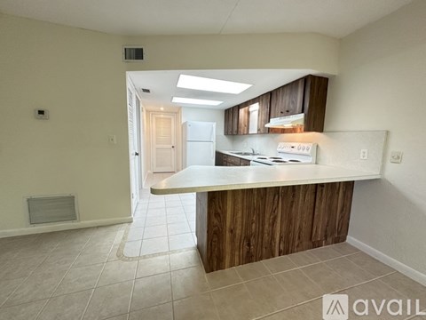 A kitchen area with a counter and cabinets.