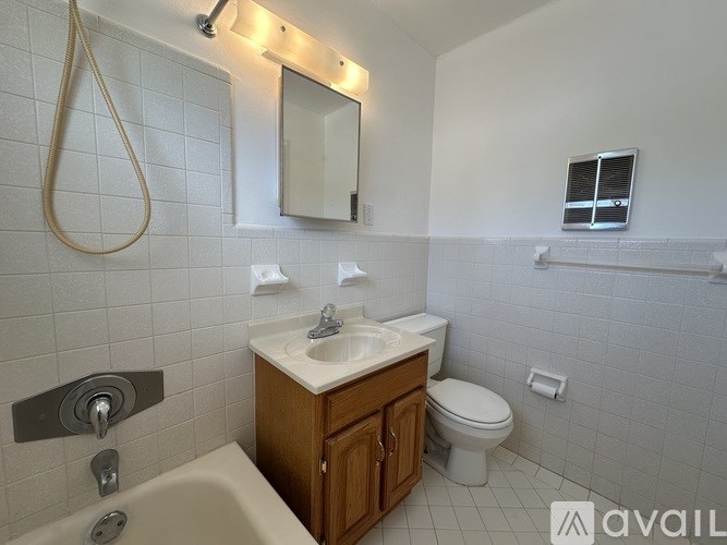 A bathroom with a sink, toilet, and bathtub.