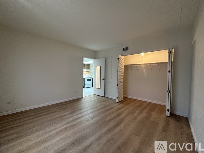 A room with wooden flooring and a sliding door.