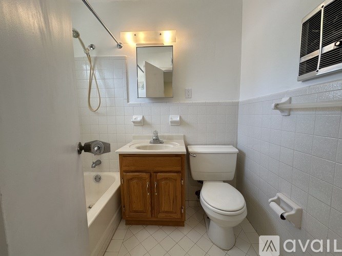 A bathroom with a toilet, sink, and bathtub.