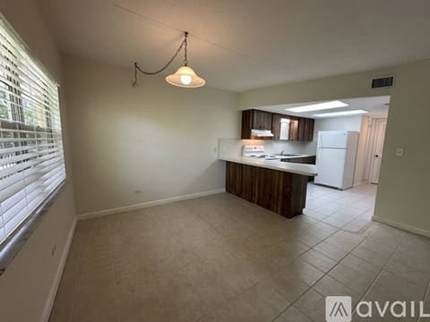 A kitchen area with a counter and a fridge.