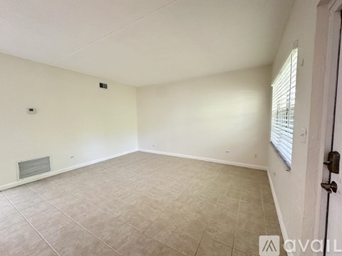 A room with white walls and a tiled floor.
