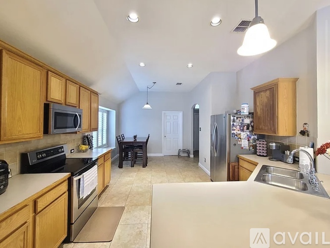 A kitchen with wooden cabinets and a black stove top oven.
