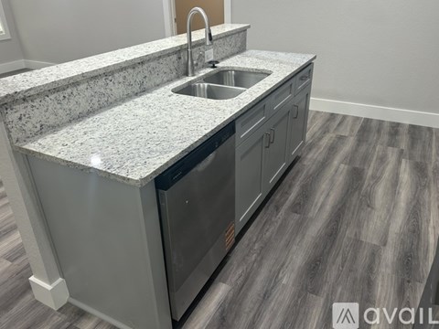 A kitchen counter with a sink and a microwave.