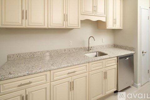 A kitchen with a granite countertop and a sink.
