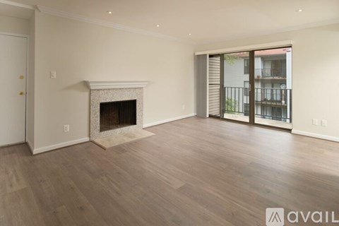 A spacious living room with a fireplace and sliding glass doors.
