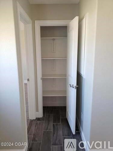 A hallway with a doorway leading to a bedroom.