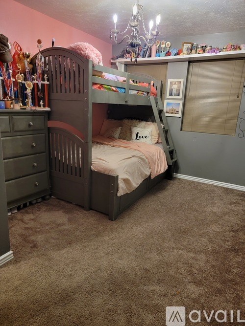 A bedroom with a bunk bed and a dresser.