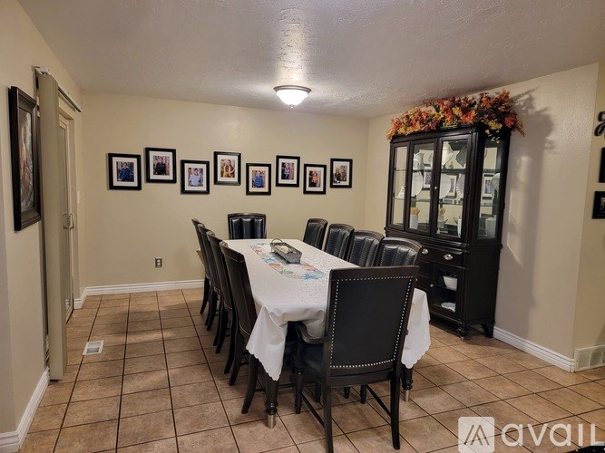 A dining room with a table set for a meal.