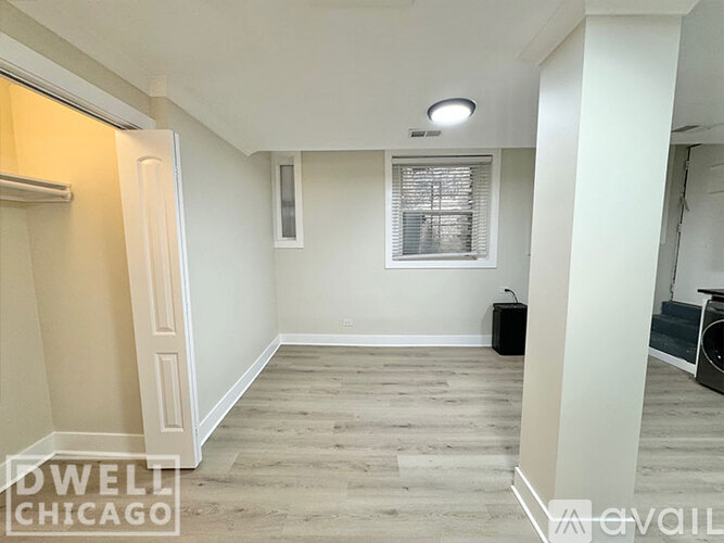 A room with a window and a door is available for rent.