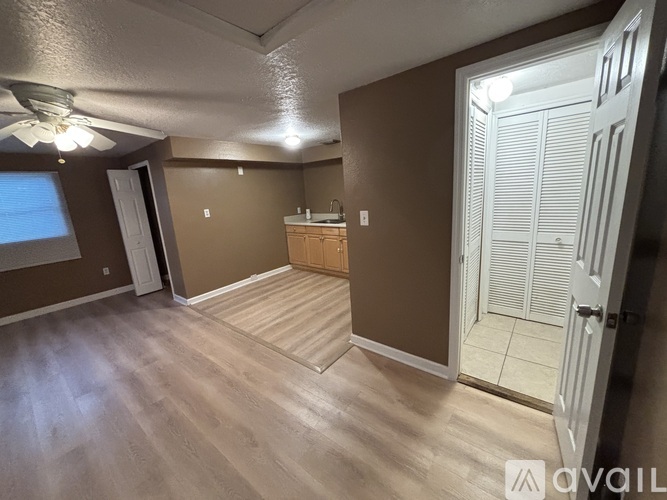 A room with brown walls and a wooden floor.