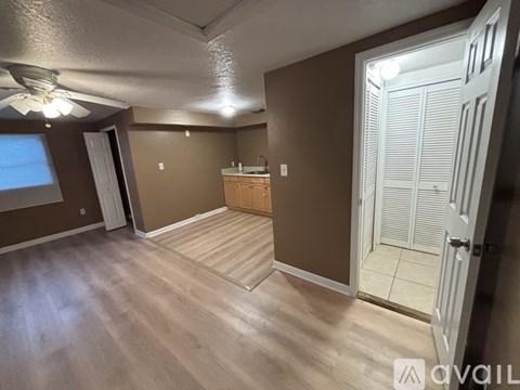 A room with brown walls and a wooden floor.