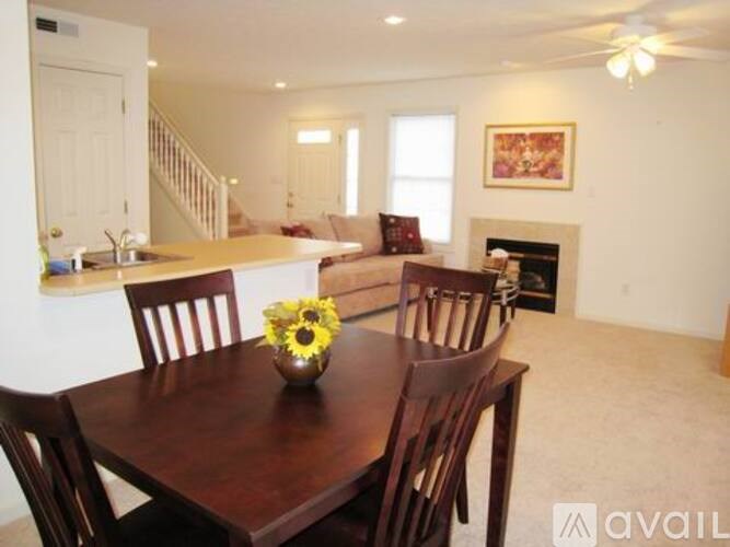 A dining room with a wooden table and chairs.