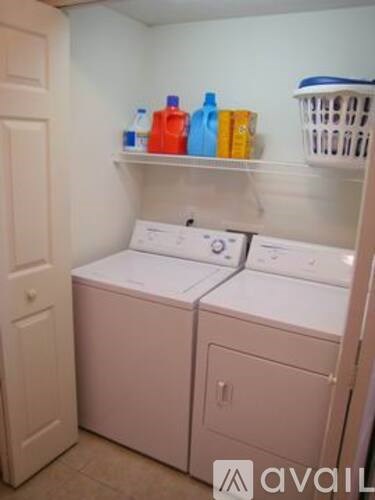 A small laundry room with a washer and dryer.