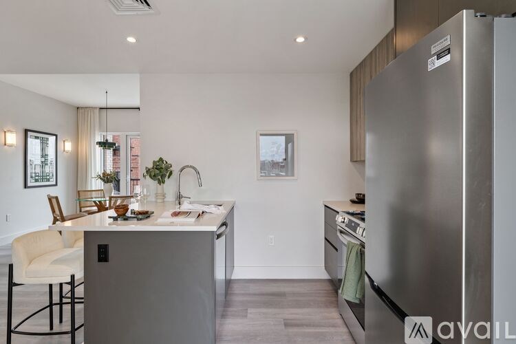 A modern kitchen with a refrigerator on the right side.