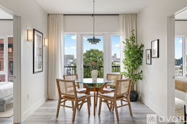A dining room with a table and chairs.