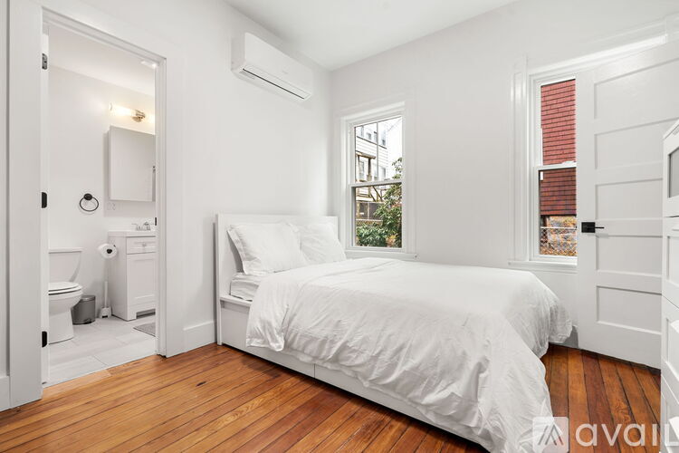 A green door is in a white room.