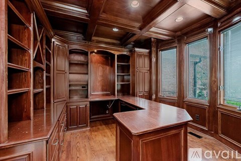 A kitchen with wooden cabinets and a countertop is available for rent.