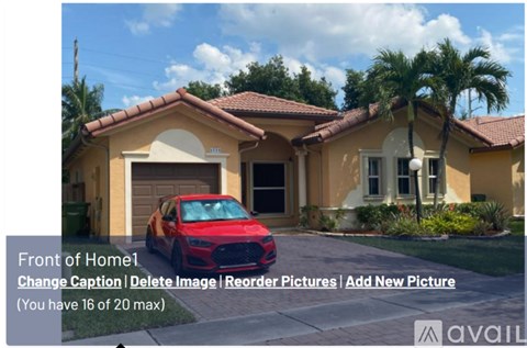 A red car is parked in front of a house.