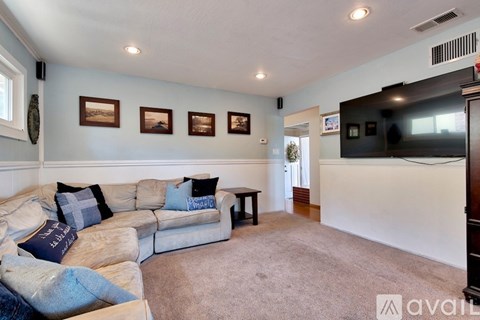 A living room with a couch and a television.