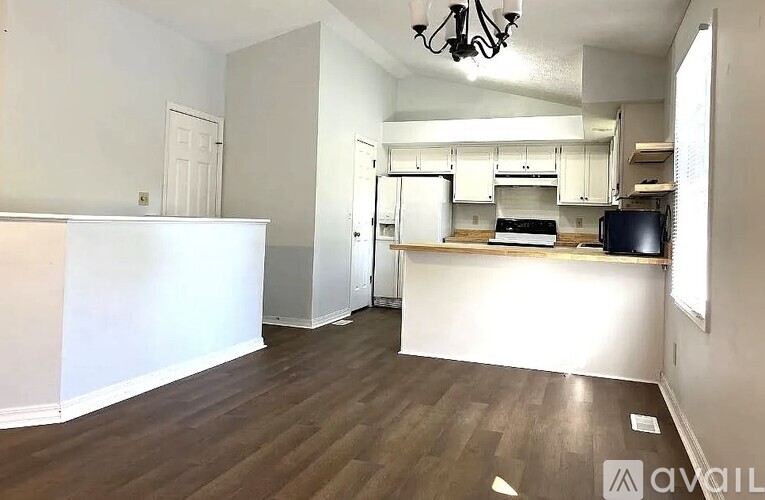 A kitchen area with a refrigerator, oven, and microwave.