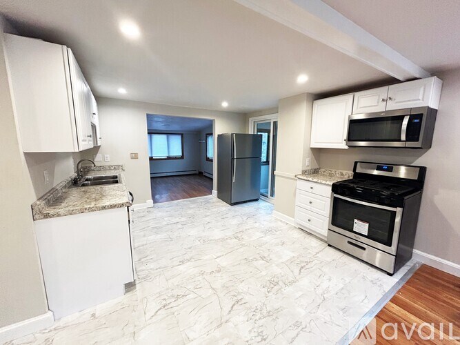 A kitchen with granite countertops and stainless steel appliances.