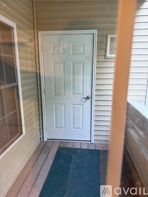 A white door is on the left side of a house.