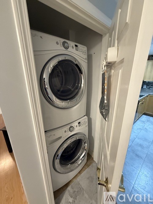 A washing machine is built into a cabinet.