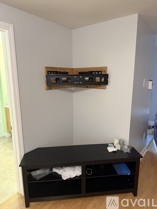 A black coffee table with a drawer underneath it and a shelf above it.