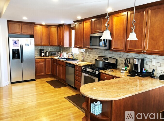 A kitchen with wooden cabinets and a granite countertop.