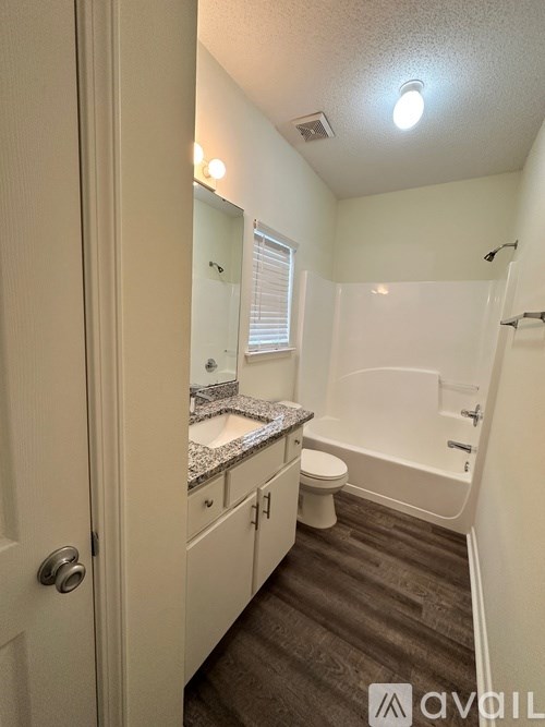 A small bathroom with a toilet, sink, and bathtub.