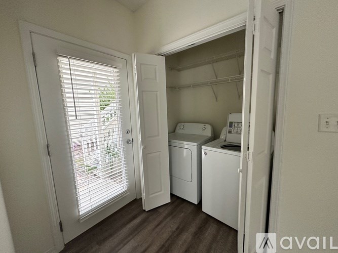 A small laundry room with a washer and dryer.