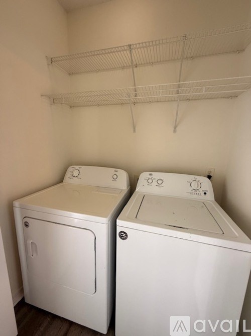 A kitchen with white appliances and cabinets.