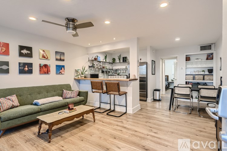 A living room with a green couch and a wooden coffee table.