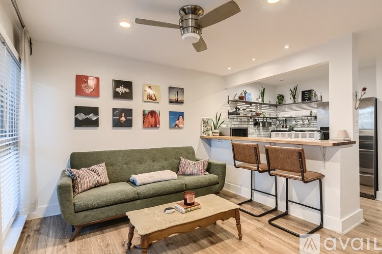 A living room with a green couch and a coffee table.
