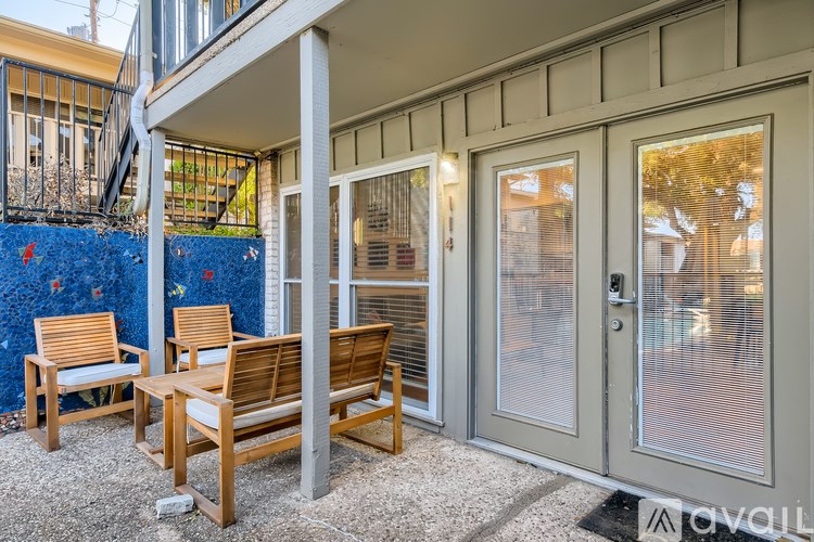 A patio with a bench and a table is shown.