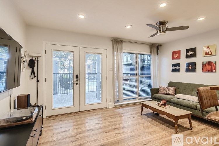 A living room with a couch, a chair, and a coffee table.
