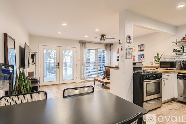 A modern kitchen with a large island and stainless steel appliances.