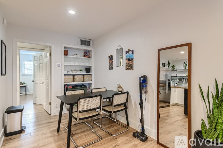 A dining area with a table and chairs is shown in the image.