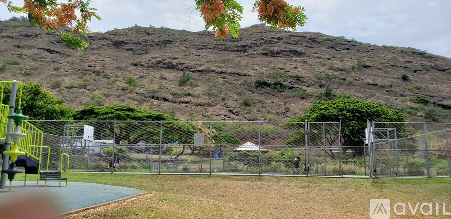 A playground with a hill in the background.