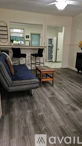 A living room with a grey couch and a wooden coffee table.