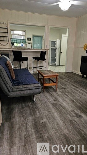 A living room with a grey couch and a wooden coffee table.